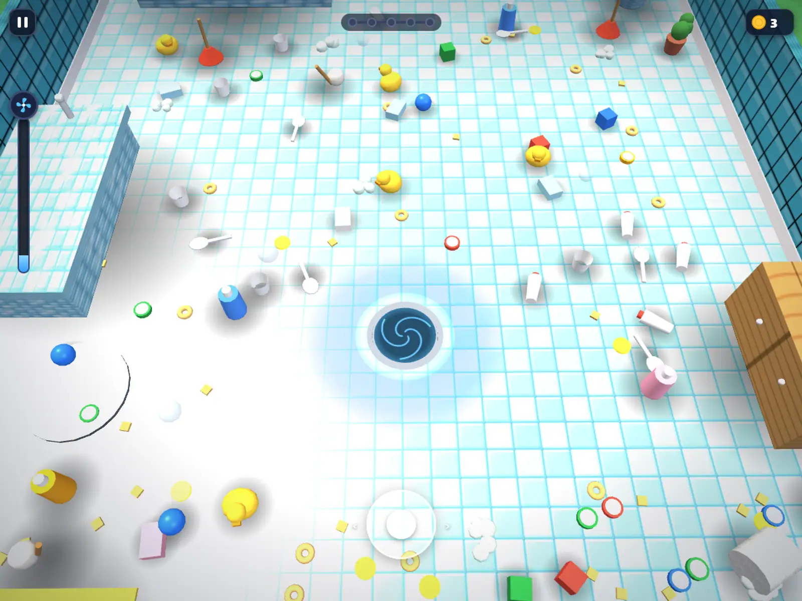 A whirlpool drain in the middle of a tiled bathroom floor strewn with small toys and rings.